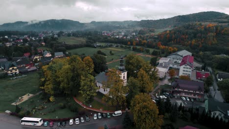 Luftaufnahmen-Der-Weißen-Kirche-An-Einem-Bewölkten,-Nebligen-Herbsttag