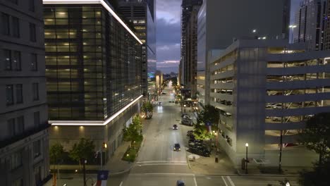 Aerial-view-flying-through-the-city,-over-the-quiet-Texas-avenue,-evening-lights-in-Houston,-USA