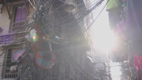A-tangled-jumble-of-wires-hangs-over-the-busy-downtown-streets-of-Kathmandu,-Nepal