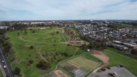 Aerial-over-Quarry-Park-with-mountain-bike-trails-and-houses,-Melbourne