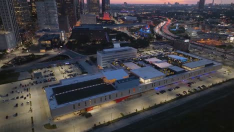 Aerial-view-towards-the-POST-Houston-Cultural-center,-dusk-in-Texas,-USA---tilt,-drone-shot