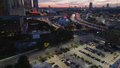 Aerial-view-towards-the-Downtown-Aquarium-and-the-Aqua-Carousel,-dusk-in-Houston,-USA