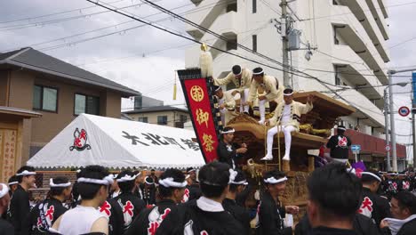 Japanese-Men-Sit-on-Danjiri-Float-waiting-for-Kishiwada-Festival-to-Begin