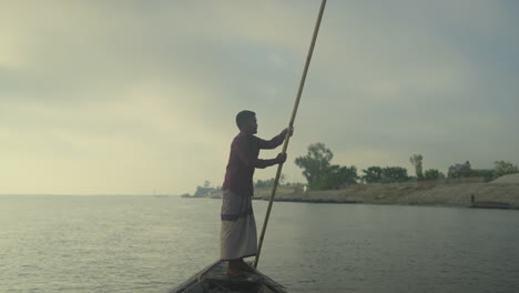 Bangladeshi-Boatman-rowing-with-oars-in-the-river-with-maximum-effort-4k-10-bit-422--Bangladeshi-riverside-lifestyle