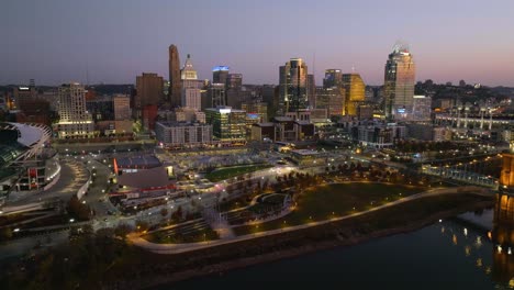 Aerial-view-around-the-Paycor-Stadium-and-the-Cincinnati-skyline,-dusk-in-Ohio,-USA---circling,-drone-shot