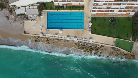 Szenische-Luftaufnahme-Eines-Strandresorts-Am-Meer-Und-Eines-Swimmingpools-In-Byblos,-Libanon