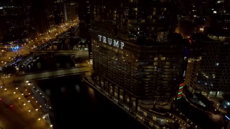 Trump-International-Hotel-and-Tower-in-downtown-Chicago,-Illinois-at-nighttime---tilt-up-reveal