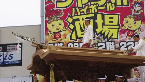 Japanese-Man-Standing-atop-Danjiri-Matsuri-Float-in-Osaka