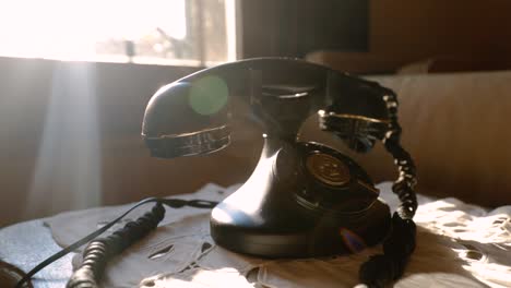 Old-Rotary-Vintage-Phone-On-The-Table-In-Front-Of-The-Window-With-Sunlight
