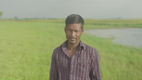 Bangladeshi-poor-man-standing-in-front-of-green