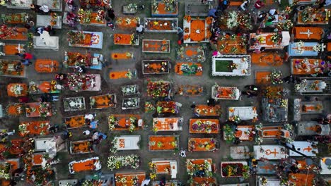 Aerial-view-above-people-lighting-candles-and-decorating-tombstones,-during-the-day-of-the-dead,-in-Mexico-city
