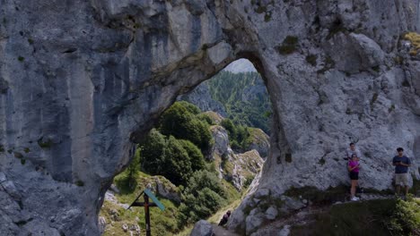 People-Exploring-Rock-Formation-In-Mountains-Near-Como-Lake,-Porta-Di-Prada-Plave,-Italy