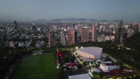 Aerial-view-around-the-National-Auditorium,-dusk-in-Mexico-city---circling,-drone-shot