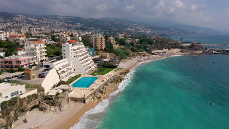 Aerial-view-flying-along-the-idyllic-Mediterranean-coast-in-Byblos,-Lebanon