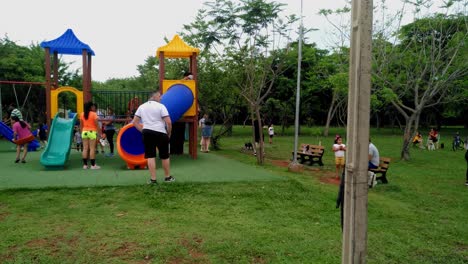 Litte-children-playing-in-the-attraction-that-the-small-park-has-in-Asuncion,-Paraguay