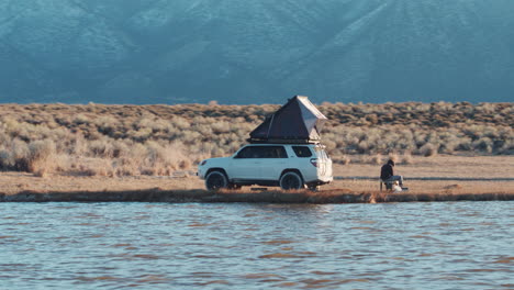 Basic-camping-with-roofnest-on-car-in-wild-nature-of-America,-aerial