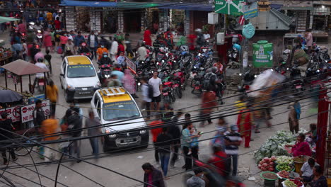 A-tourist-stands-still-in-the-middle-of-a-time-lapse-on-the-bustling-streets-of-Kathmandu,-Nepal