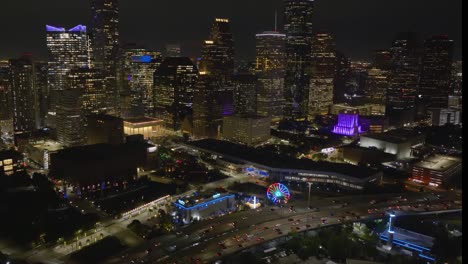 Aerial-view-of-the-illuminated-Downtown-Aquarium-and-the-Aqua-Carousel,-evening-in-Houston,-USA