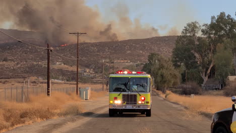 A-firetruck-drives-away-from-a-wildfire