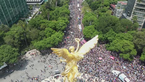 Aerial-tilt:-Gay-Pride-celebration-mass-with-gold-angel-sculpture