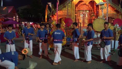 Traditional-male-Thai-dance-group-performing-at-temple-grounds-during-night
