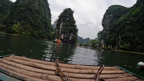 Timelapse-From-Front-Of-Boat-Rowing-Along-River-In-Ninh-Binh-Past-Limestone-Cliffs-Sightseeing