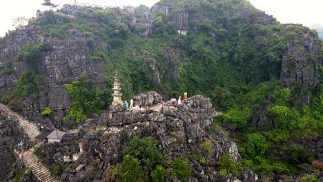 Hang-Mua-Viewpoint-With-Pagoda-With-Limestone-Cliffs-In-Background