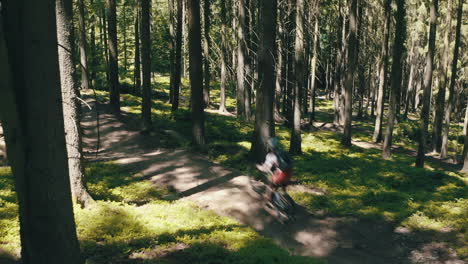 A-group-of-three-men-riding-mountain-bikes-fast-down-the-trail---cinematic-moving-camera-shot
