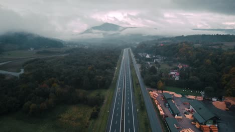 Aerial-shot-of-highway-and-cars-covered-in-fog