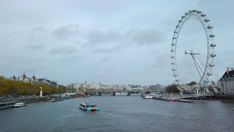 London,-Westminster-|-United-Kingdom--:-Aerial-drone-video-of-iconic-giant-Ferris-Wheel-of-London-eye-in-front-of-river-Thames-and-houses-of-Parliament-and-Big-Ben