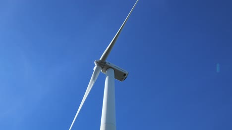 Shot-of-underside,-underneath-spinning-wind-turbine