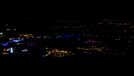 Festival-of-Christmas-lights-in-a-garden-park---aerial-parallax-view