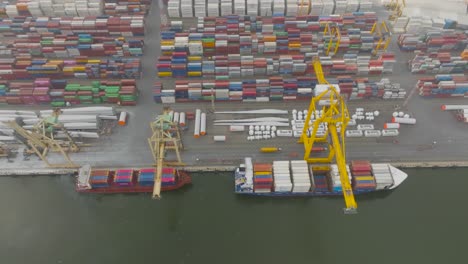 Aerial-view:-container-ships-are-standing-in-the-container-terminal-and-waiting-with-cargo