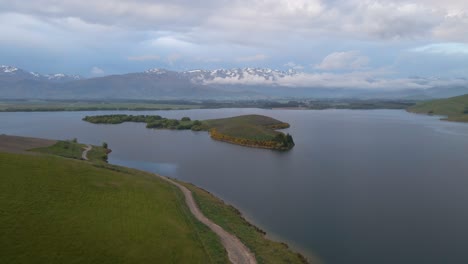 Drone-footage-of-a-tiny-island-on-lake-Opuha-at-the-foothills-of-New-Zealand's-southern-alps