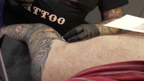 Closing-up-of-a-tattoo-artist-tatooing-someone-his-arm