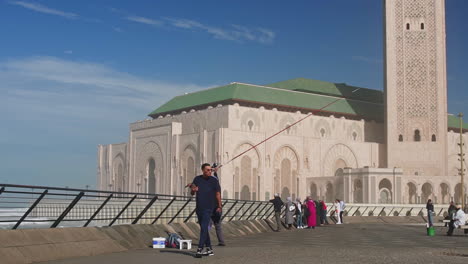 Fisherman-in-front-of-Hassan-II-mosque-in-Casablanca-Morocco