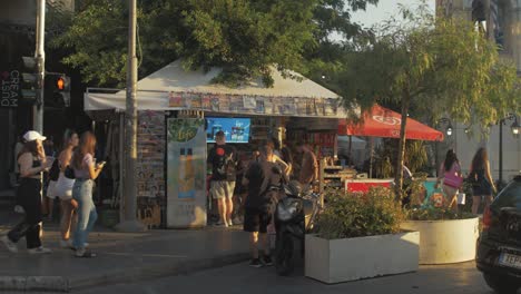 People-congregate-around-kiosk-in-Monastiraki-downtown-Athens
