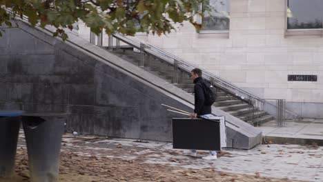 Man-walking-around-with-a-pool-table-in-the-center-of-brussels,-Belgium-