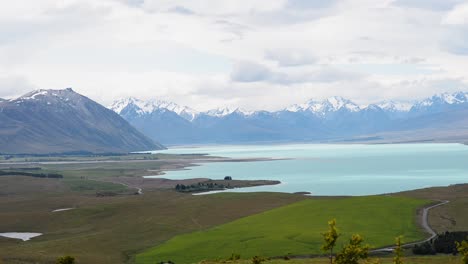 Lake-Tekapo-with-snow-capped-mountain-range-in-background-viewed-from-the-top-of-Mount-John