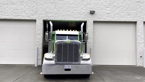 green-peterbilt-tractor-pulls-out-of-garage