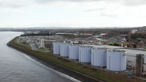 Aerial-establishing-shot-of-a-large-sewage-plant-in-Edinburgh-by-the-coast