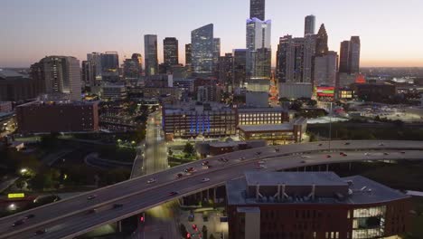 Establishing-aerial-view-of-the-University-of-Houston-downtown-and-the-skyline,-during-dawn