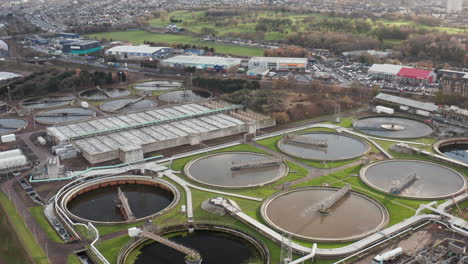 Aerial-shot-zooms-in-towards-a-large-sewage-processing-plant-in-Edinburgh-on-a-grey-day