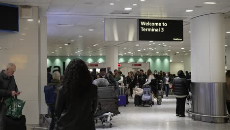 People-welcoming-family-at-Terminal-3-Arrivals-at-Heathrow-Airport,-coming-home-for-Christmas