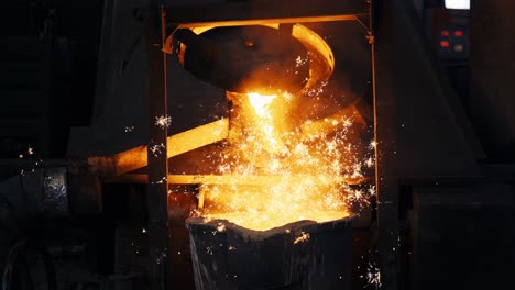 Pouring-bright-hot-liquid-steel-or-metal-from-ladle-in-blast-furnace-foundry-metallurgical-factory
