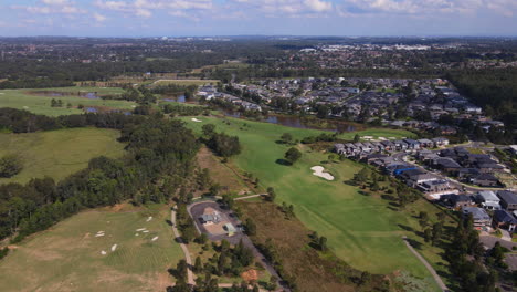 High-drone-Aerial-shot-of-Australian-residential-suburb-large-houses-golf-course---Colebee-NSW