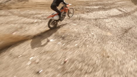 Fast-FPV-drone-follows-dirt-bike-racers-and-quad-rider-on-dirt-track