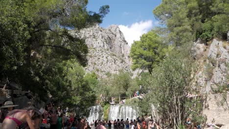 Tourist-refreshing-at-river-course-in-spring-water-pools-at-Fonts-de-L'Algar,-Alicante,-Spain