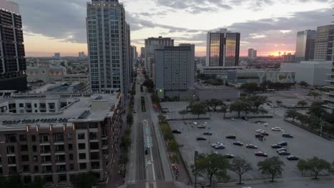 Aerial-view-over-the-Main-street,-revealing-the-sunset-above-Midtown,-Houston,-USA