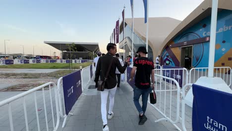 people-are-getting-entering-into-the-Doha-Qatar-Metro-Station-walking-at-sun-talking-together-and-cold-station-inside-in-very-hot-and-humid-outside-staff-with-blue-jacket-and-spectacular-architecture